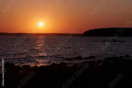 Beautiful sunset on the Gulf of Finland. Typical northern summer landscape. © gogiya