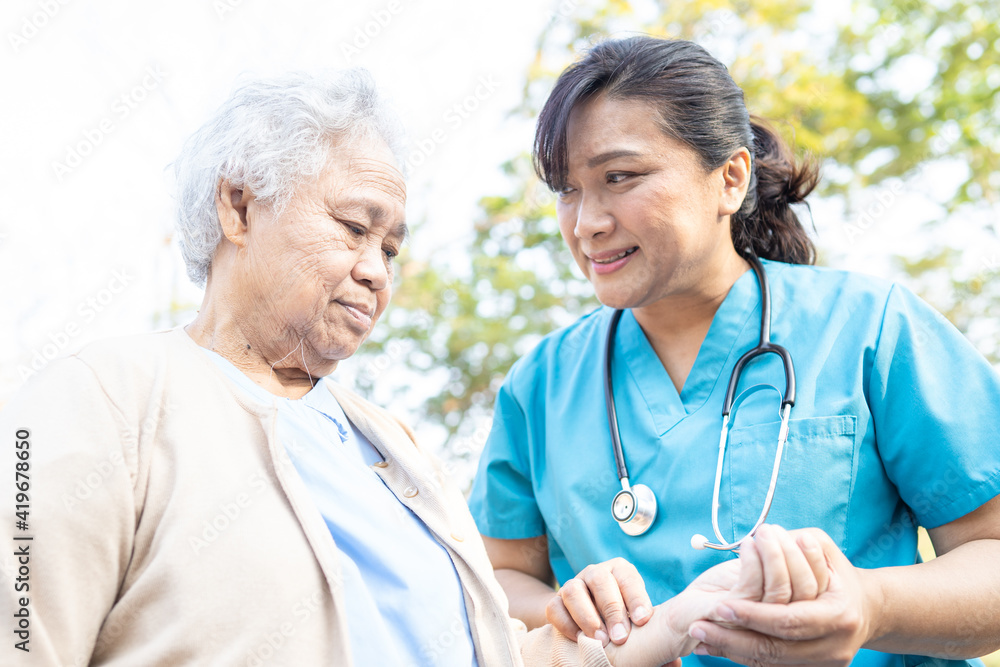 Doctor help and care Asian senior or elderly old lady woman walking at park in happy fresh holiday. Doctor help and care Asian senior or elderly old lady woman walking at park in happy fresh holiday.