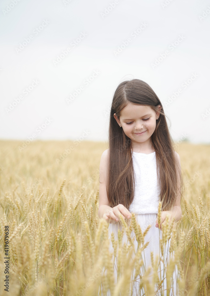 Cute child has fun outdoors. Little cute girl posing in the meadow. Cute child has fun outdoors. Little cute girl posing in the meadow.