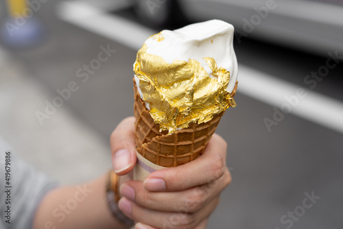 Gloden milk vanilla icescream cone ,gold on top in Japan. photo