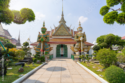 Wat Arun Ratchawararam of giants front of the church and nobody in front Entrance door buddhist temple of tourists and landmark popular tourist attractions and cultural attractions in BANGKOK THAILAND