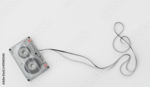 Tape coming out from musicassette treble clef shape on white background
