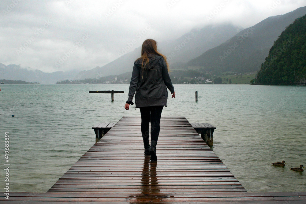 Woman Walking down a Dock