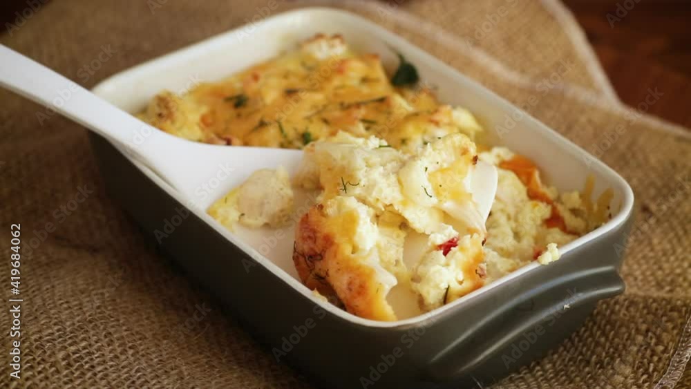 baked cauliflower with chicken fillet and vegetables topped with cheese baked cauliflower with chicken fillet and vegetables topped with cheese