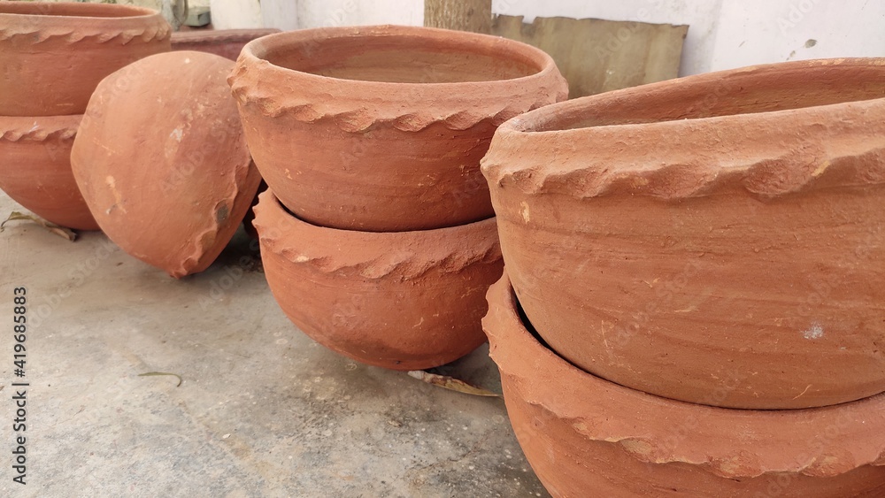 Terracotta clay pot used to grow plant in home made all by hands by a potter on potters wheel Terracotta clay pot used to grow plant in home made all by hands by a potter on potters wheel