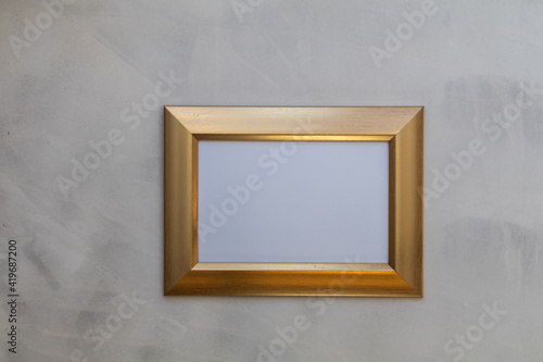 Gold frame mockup on gray wash background flat lay copy space