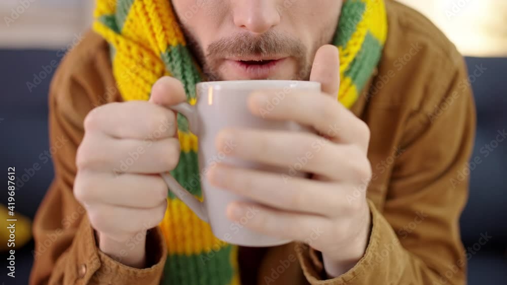 Sick male drinking hot beverage, suffering from fever, respiratory infection Sick male drinking hot beverage, suffering from fever, respiratory infection