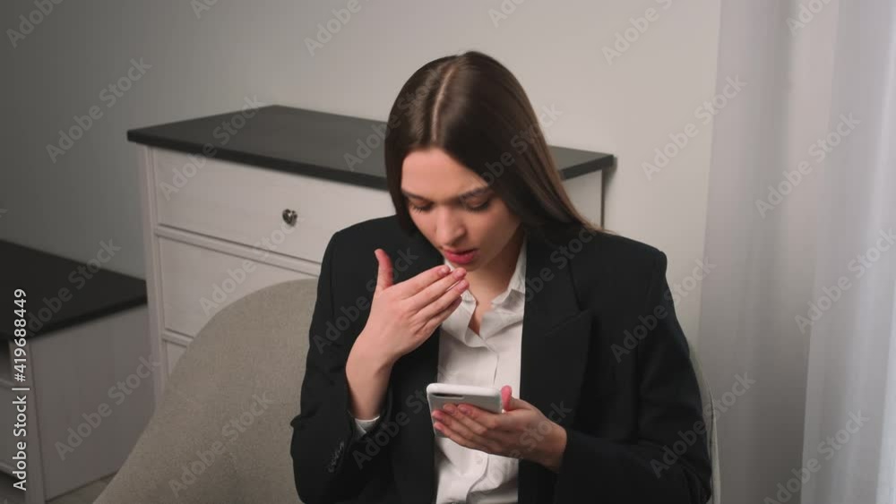 Pretty caucasian woman using phone coughs at home office. Businesswoman looking and typing on phone, woman feels bad at office. Pretty caucasian woman using phone coughs at home office. Businesswoman looking and typing on phone, woman feels bad at office.