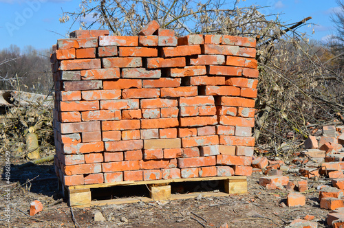 A stack of old bricks on a pallet. Sale of building materials.