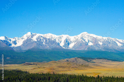 Beautiful mountain landscape. Snow-capped mountains, steppe and conifers. Russia, Altai mountains, Chuysky ridge