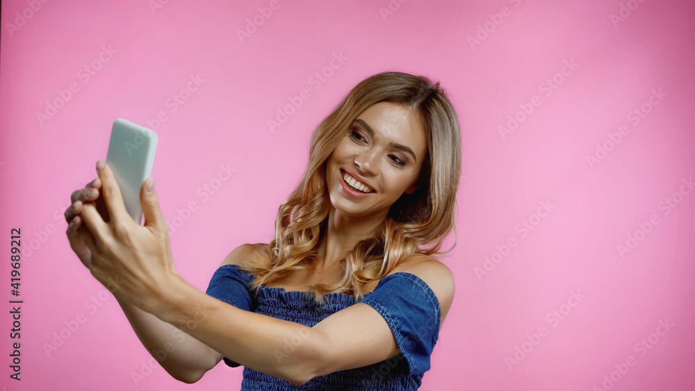 smiling young woman taking selfie isolated on pink smiling young woman taking selfie isolated on pink