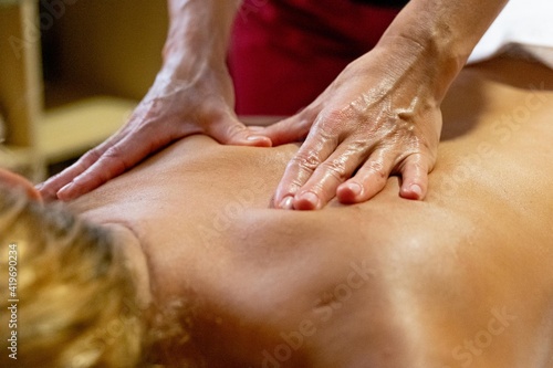 Chiromassage therapist giving a back massage to a client