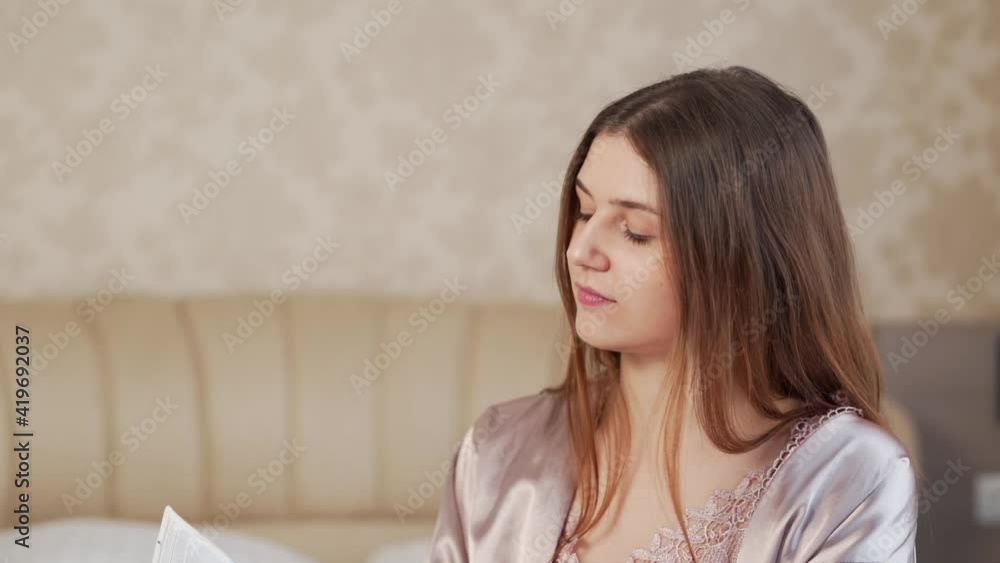 Beautiful young girl in night pajamas applies cream to the skin Beautiful young girl in night pajamas applies cream to the skin