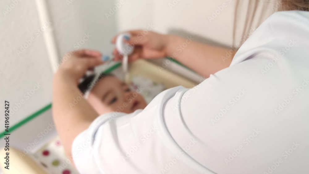 Newborn baby get examine by pediatrician hold stethoscope, pediatric doctor monitoring heart pulse rate adorable infant in clinic, pediatrician with child concept. Newborn baby get examine by pediatrician hold stethoscope, pediatric doctor monitoring heart pulse rate adorable infant in clinic, pediatrician with child concept.