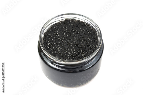 black caviar in a glass jar. isolated on white background.