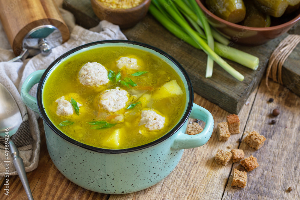Healthy and diet food. Soup with meatballs and bulgur on a wooden table. Healthy and diet food. Soup with meatballs and bulgur on a wooden table.