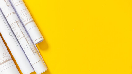 Construction project drawings concept. Architecture Blueprints on yellow color background, copy space
