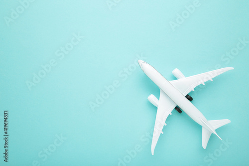 Model airplane on blue pastel color background.