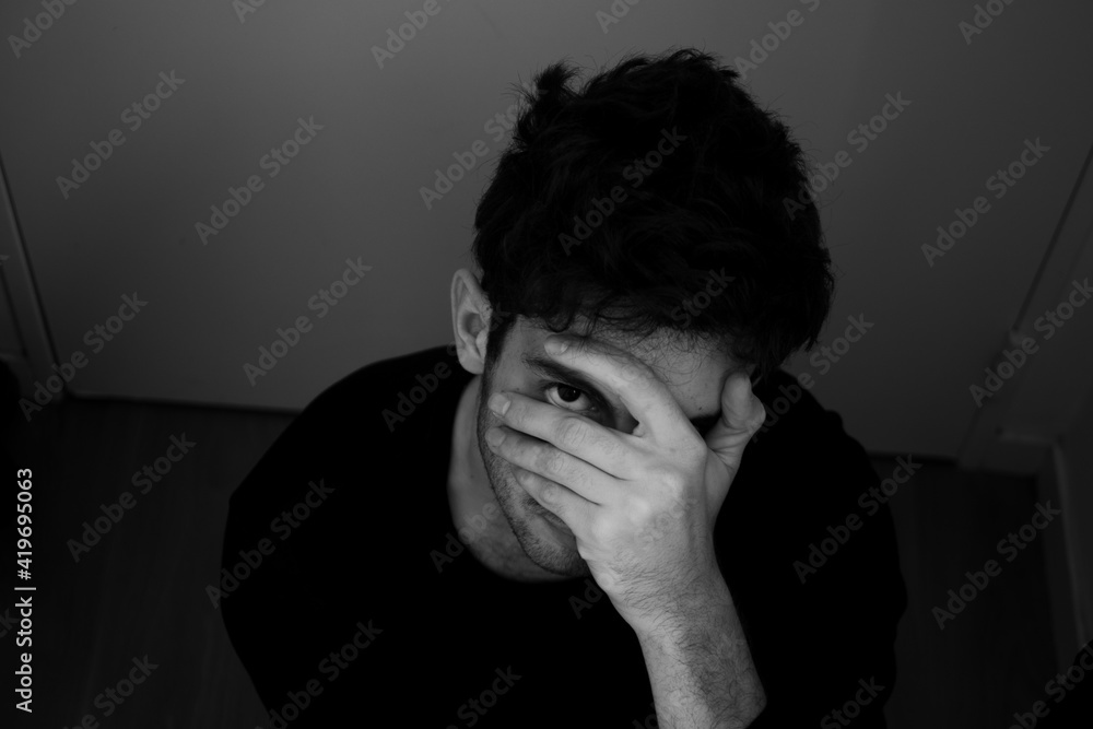 Teenager portrait sadness takes his head in his hands black and white Teenager portrait sadness takes his head in his hands black and white