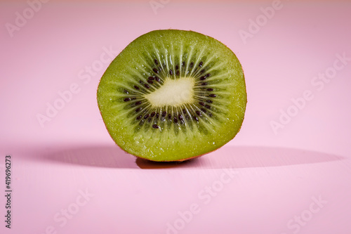 Kiwi on an orange background, macro photo