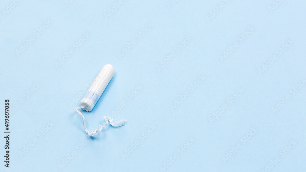 White tampon on the blue background, medical banner White tampon on the blue background, medical banner