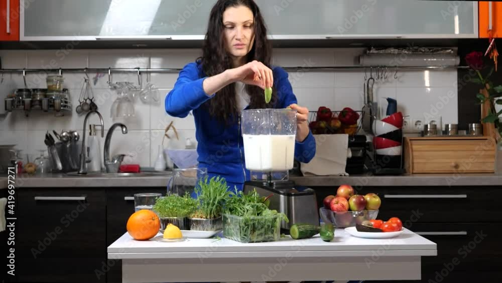 girl in kitchen making smoothie for detox girl in kitchen making smoothie for detox