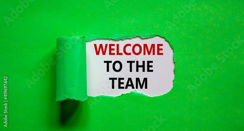 Welcome to the team symbol. Words 'Welcome to the team' appearing behind torn green paper. Beautiful green background. Business, welcome to the team concept, copy space.