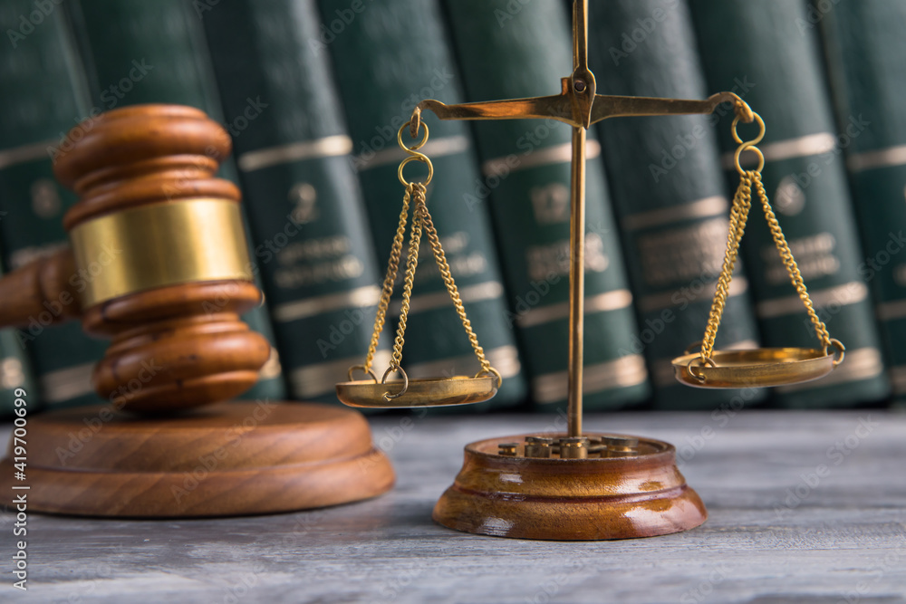 Law and Justice Symbols with law books on background. Law and Justice Symbols with law books on background.