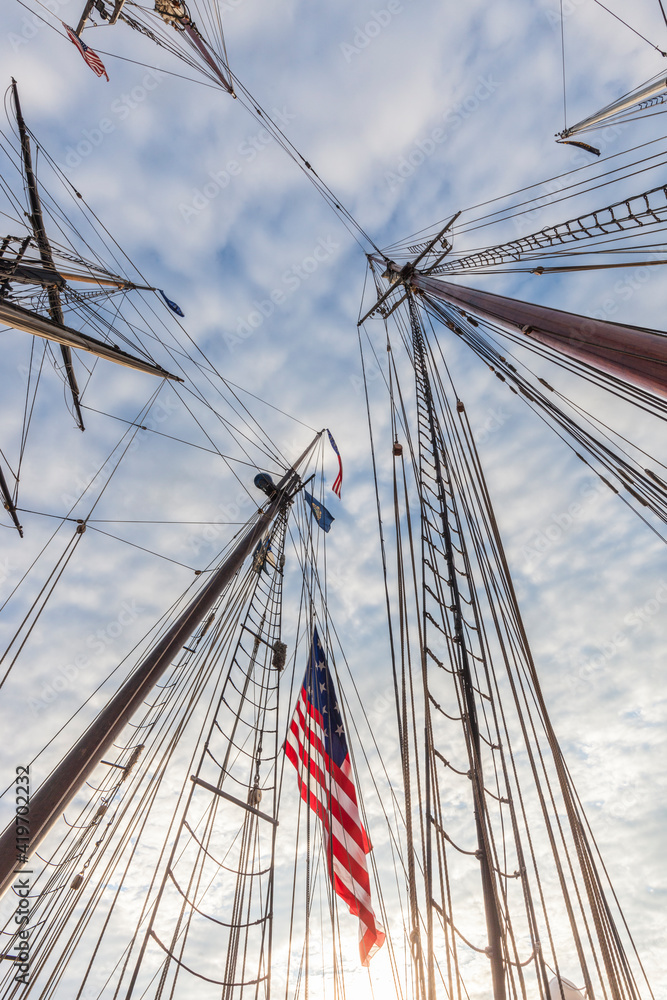 Fototapeta premium USA, Massachusetts, Cape Ann, Gloucester. Gloucester Schooner Festival, schooner masts and US flag.