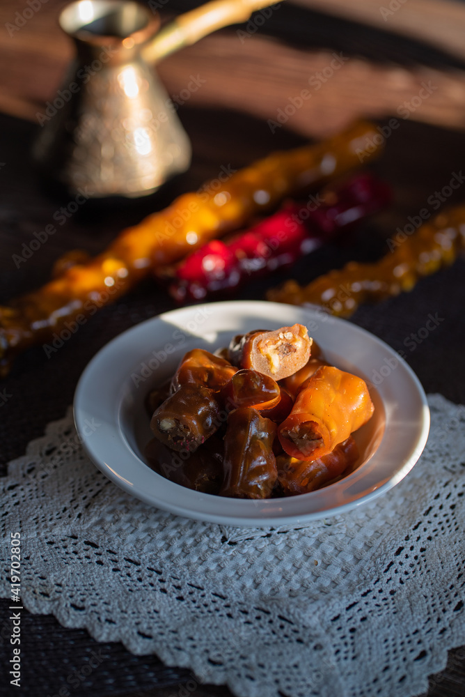 oriental sweet with nuts - churchkhela on a wood background oriental sweet with nuts - churchkhela on a wood background
