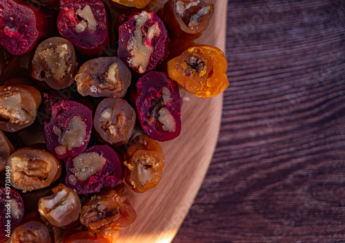 oriental sweet with nuts - churchkhela on a wood background