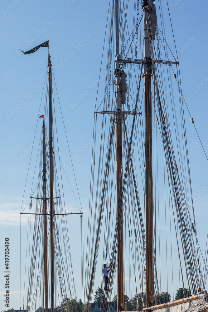 USA, Massachusetts, Cape Ann, Gloucester. Gloucester Schooner Festival, schooner masts at dawn. USA, Massachusetts, Cape Ann, Gloucester. Gloucester Schooner Festival, schooner masts at dawn.