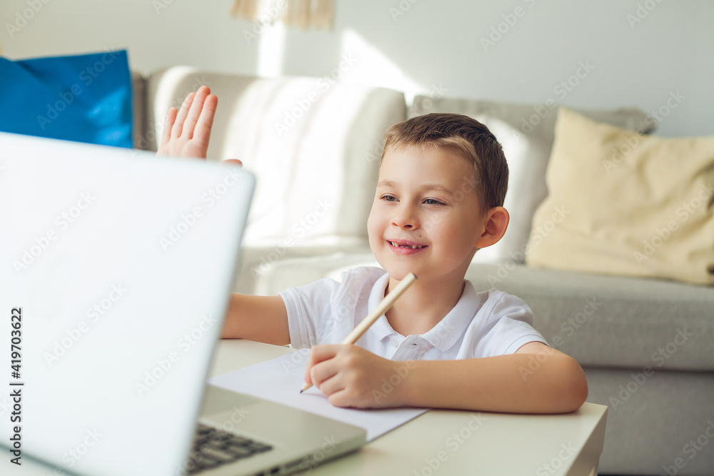 Schoolboy is studying online. The boy is engaged. Quarantine. Schoolboy is studying online. The boy is engaged. Quarantine.