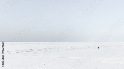 People on the background of the frozen sea