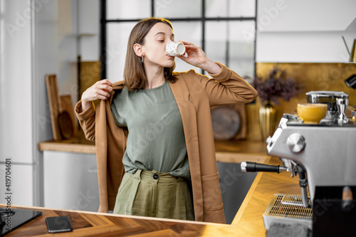 Bild auf Leinwand Fussy young businesswoman in a hurry to work in the morning, wearing jacket, dri