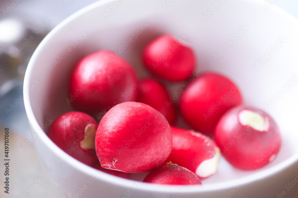 Fresh radishes in a white cup. Fresh radishes in a white cup.