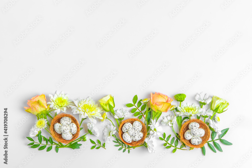 Creative layout composition of flowers and easter eggs on pastel background.