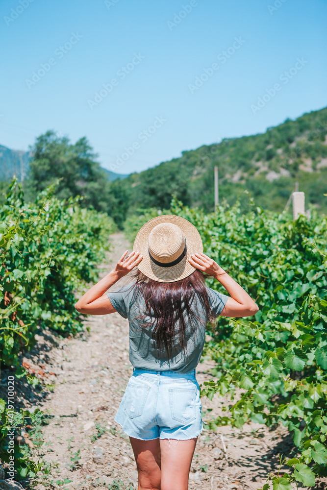 Young woman enjoying nature on the field of sunflowers.