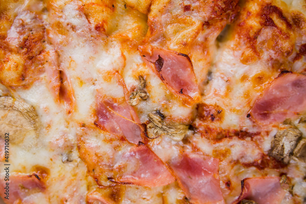pizza with ham and mushrooms closeup texture background pizza with ham and mushrooms closeup texture background
