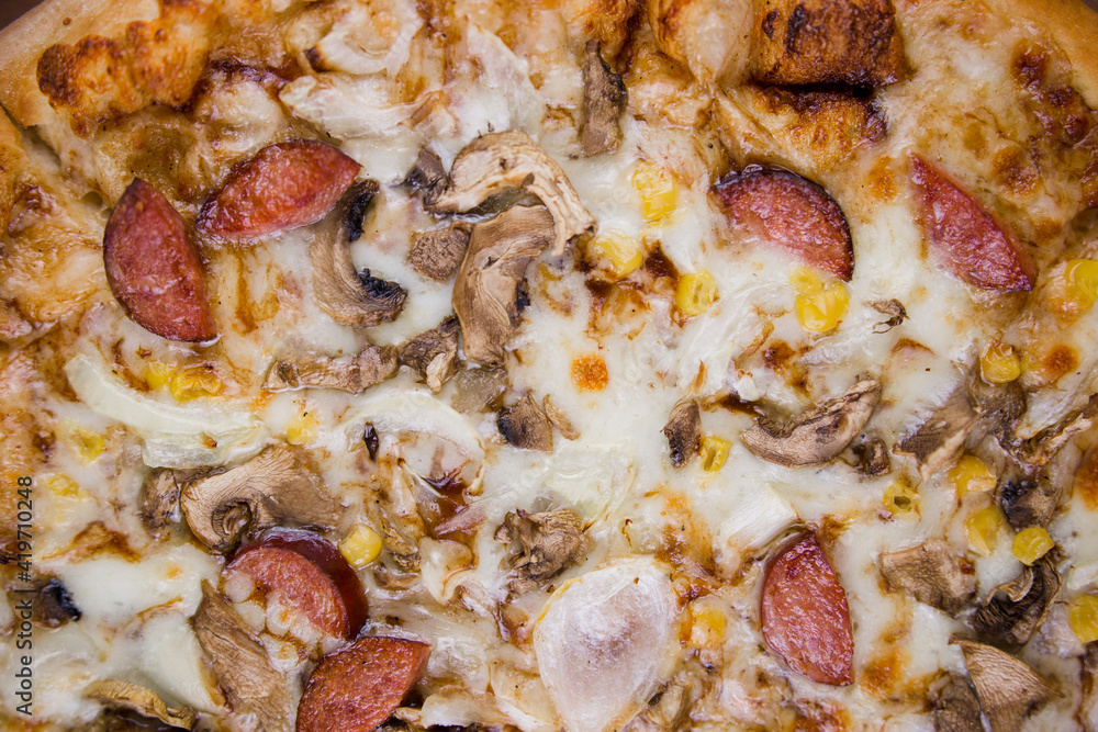 pizza with sausages and mushrooms close-up cheese pizza with sausages and mushrooms close-up cheese