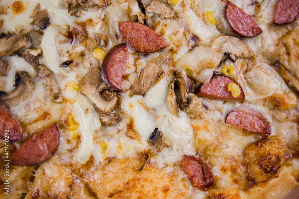 pizza with sausages and mushrooms close-up cheese pizza with sausages and mushrooms close-up cheese
