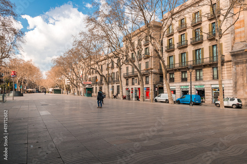 Photography Picture of La Rambla of Barcelona during midday with people walking and the sunlight illuminating them