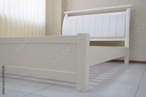 white wooden bed with soft bedhead