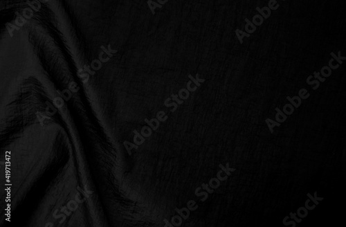 Fabric or canvas. A piece of crumpled fabric of dark gray color. Material for sewing clothes