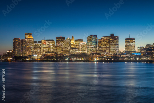USA  Massachusetts  Boston. City skyline from Boston Harbor at dusk.