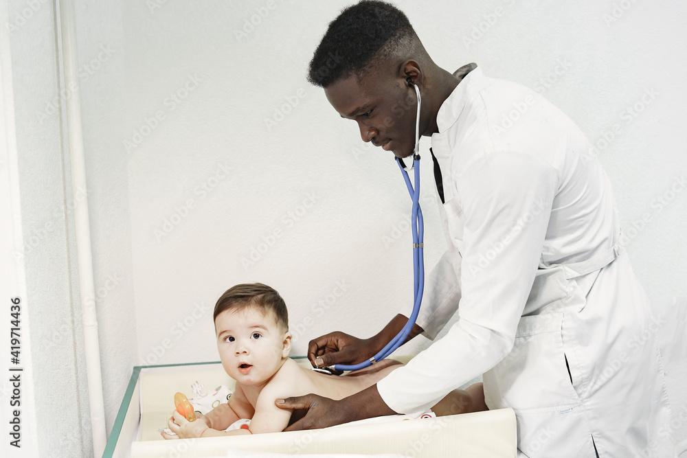Black doctor. Baby in diaper. African with stethoscope. Black doctor. Baby in diaper. African with stethoscope.