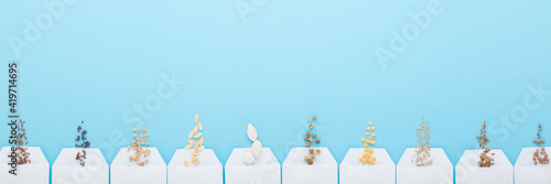 Photography Many white packs of different seeds on light blue table background