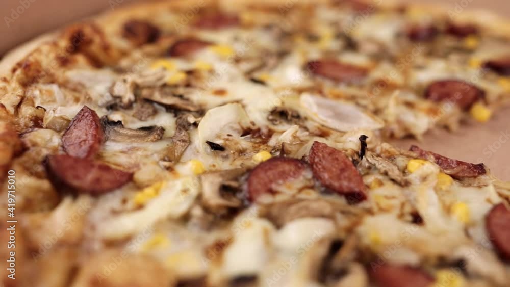 pizza with sausages and mushrooms close-up with cheese pizza with sausages and mushrooms close-up with cheese
