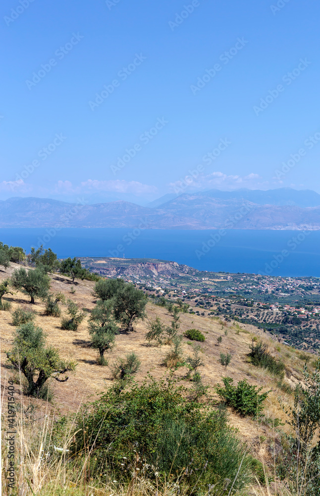 View of the mountains, village and the sea from the cliff (Greece, Peloponnese)