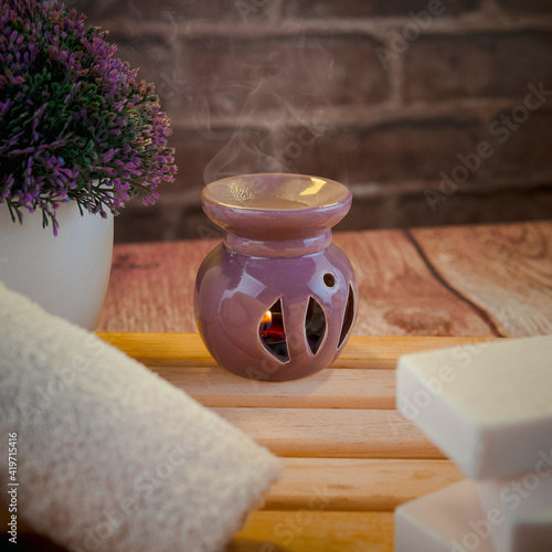 Beautiful spa composition with natural soaps with scented candles and bathroom accessories in a romantic setting for a cleansing concept. There is shallow depth of field and room for text.